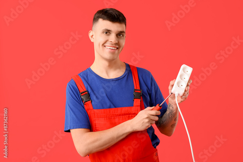 Young male electrician with...