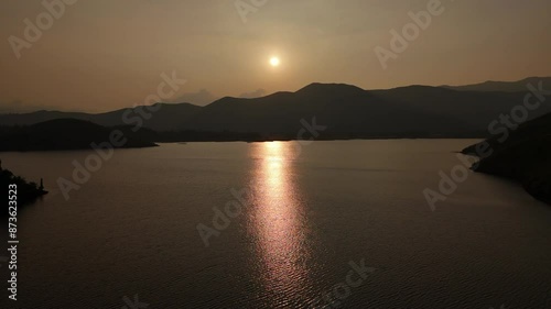 Aerial view of  forest grass meadow and lake red water sunset water in chikmagalur karnataka india. photo