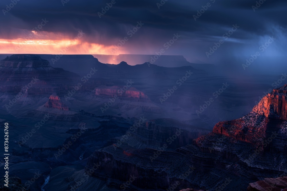Fototapeta premium Stormy blue hour landscape of majestic Grand Canyon with dramatic clouds and rays of light
