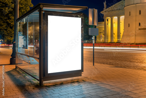 Mockup Of Bus Stop Advertising Billboard On A City Street At Night. Poster Light Box With Car Light Trails In The Background