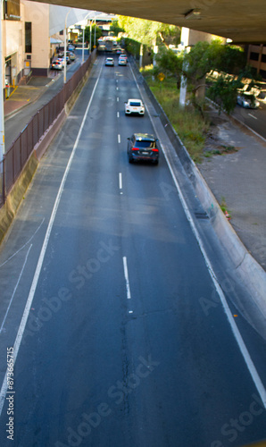 Capture the essence of Sydney CBD's New South Wales with this stunning photograph of a picturesque road. The scene showcases the heart of the city, where modern architecture meets lush greenery