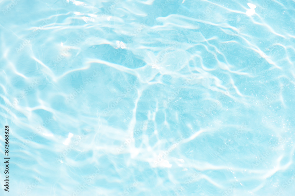 Blue water with ripples on the surface. Defocus blurred transparent blue colored clear calm water surface texture with splashes and bubbles. Water waves with shining pattern texture background. Blue water with ripples on the surface. Defocus blurred transparent blue colored clear calm water surface texture with splashes and bubbles. Water waves with shining pattern texture background.