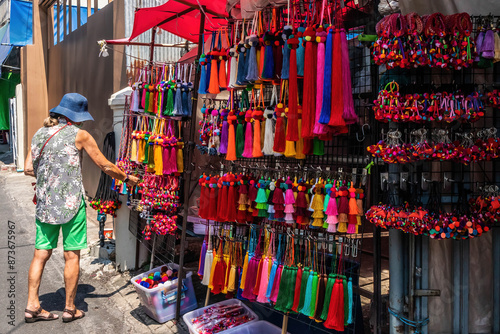 A tourist examining hill tribe souvenirs, Chian Mai, Thailand photo