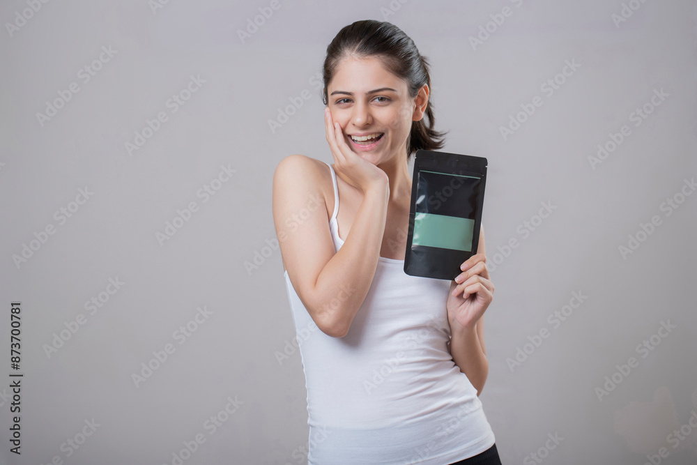 India Female Model Poses For The Camera While Holding A Face Mask Sachet India Female Model Poses For The Camera While Holding A Face Mask Sachet