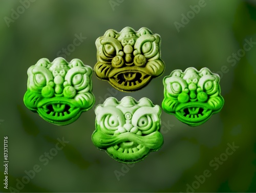 In the picture is a mold of four giant green-toned faces. It is a mold used in art and as a template for making desserts and various decorations.