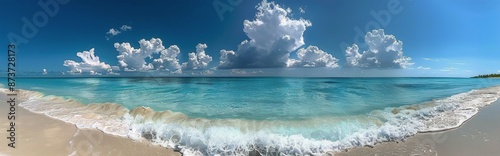 Tropical Beach Scene With White Waves Crashing On Sandy Shore Under Blue Sky