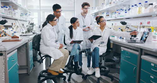 Laptop, science and group of people in laboratory for learning, cancer cure or medical development. Training, investigation and research with scientist team in clinical trial for medicine internship photo