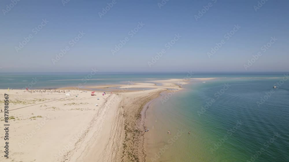 Drone reverse above beach with tidal marks along sandy shores as calm waves crash on beach, Armona Island Olhao Drone reverse above beach with tidal marks along sandy shores as calm waves crash on beach, Armona Island Olhao
