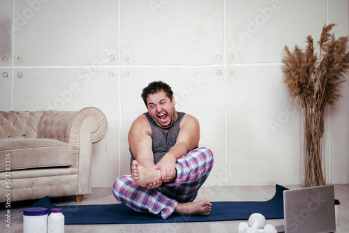Fat lazy man doing fitness at home.