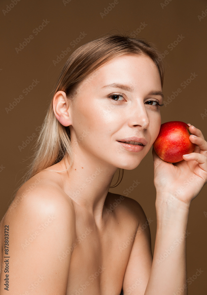 Beautiful Woman with Red Apple. A close-up portrait of a beautiful blonde woman holding a red apple against her cheek, showcasing healthy, glowing skin and a serene expression. Beautiful Woman with Red Apple. A close-up portrait of a beautiful blonde woman holding a red apple against her cheek, showcasing healthy, glowing skin and a serene expression.