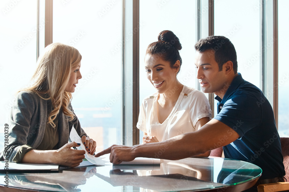 Discussion, couple and financial advisor with document for consulting, insurance plan or investment in office. Meeting, help and woman broker with people for advice, loan application or information Discussion, couple and financial advisor with document for consulting, insurance plan or investment in office. Meeting, help and woman broker with people for advice, loan application or information