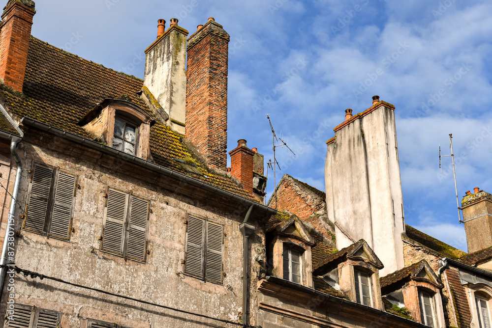 Rooftop view in Auxonne with old chimneys and roofs and windows