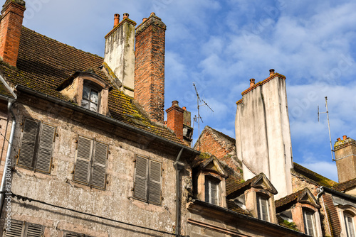 Obraz na płótnie Rooftop view in Auxonne with old chimneys and roofs and windows w salonie