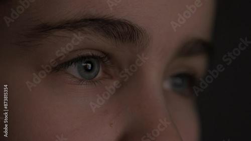 Girl in Dark is Watching TV Playing Video Game. Video Game Entertainment Emotions. Portrait Child While Watching TV. Close-up Face of Child Eyes While Person Using Tablet, Smartphone or Computer.