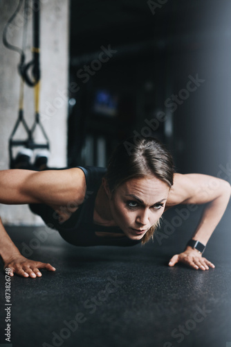 Push ups, woman and fitness in gym on ground for workout, health and wellness with power or resilience. Plank, athlete and training in sports club for exercise, competition and body goals with muscle