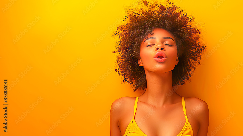 Beautiful black woman sending a kiss on yellow background Beautiful black woman sending a kiss on yellow background