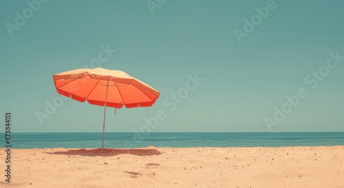 Orange Beach Umbrella on Sandy Shore Under Summer Sky