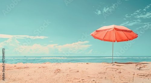 Orange Beach Umbrella on Sandy Shore Under Summer Sky