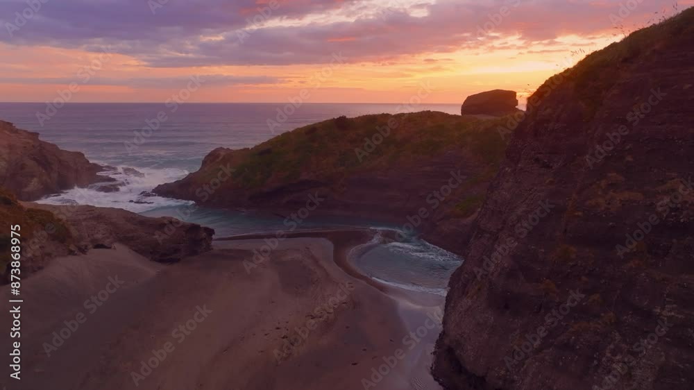 Sandy beach and cove at sunset. Piha, Auckland, New Zealand. Sandy beach and cove at sunset. Piha, Auckland, New Zealand.