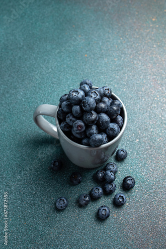 Blueberries in a cup on a dark background. Top view.