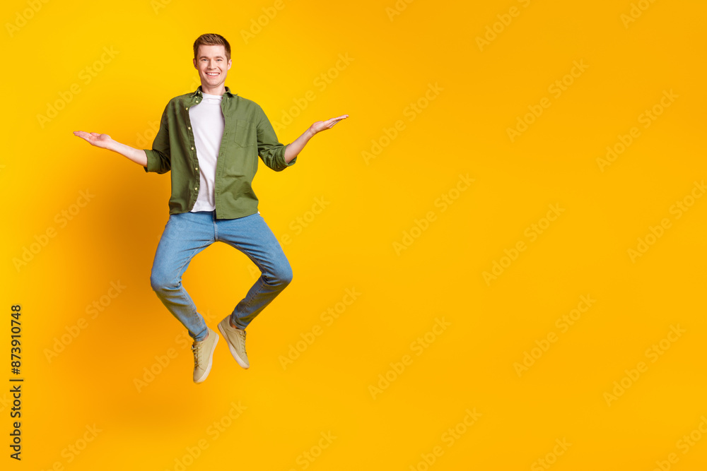 Photo of nice cheerful man wear stylish khaki clothes demonstrate empty space isolated on vivid yellow color background Photo of nice cheerful man wear stylish khaki clothes demonstrate empty space isolated on vivid yellow color background
