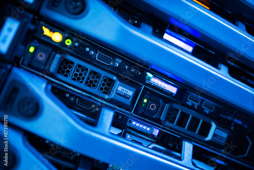 close up of network cables connected to server racks in data center room.