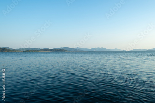 Pebble beaches. Beaches in Muğla. View from the beach to the sea. Magnificent beach, sea and blue cloudy sky.