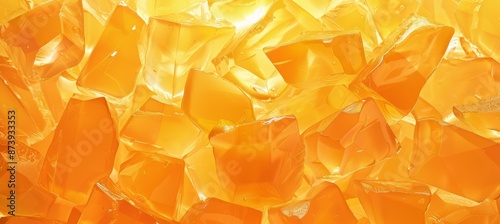 Abstract background made from orange jello chunks. Backlit clear ice or jelly cubes. Candy sweets