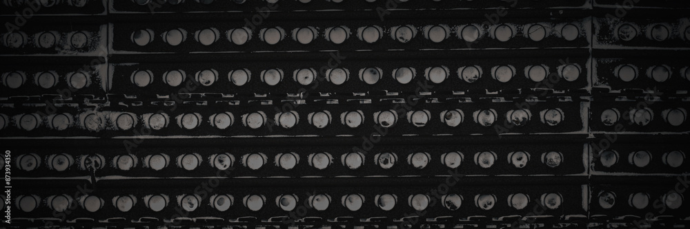 Metal texture with perforation. Snowy rusty metal fence with holes. Dark wide panoramic background for design. Metal texture with perforation. Snowy rusty metal fence with holes. Dark wide panoramic background for design.