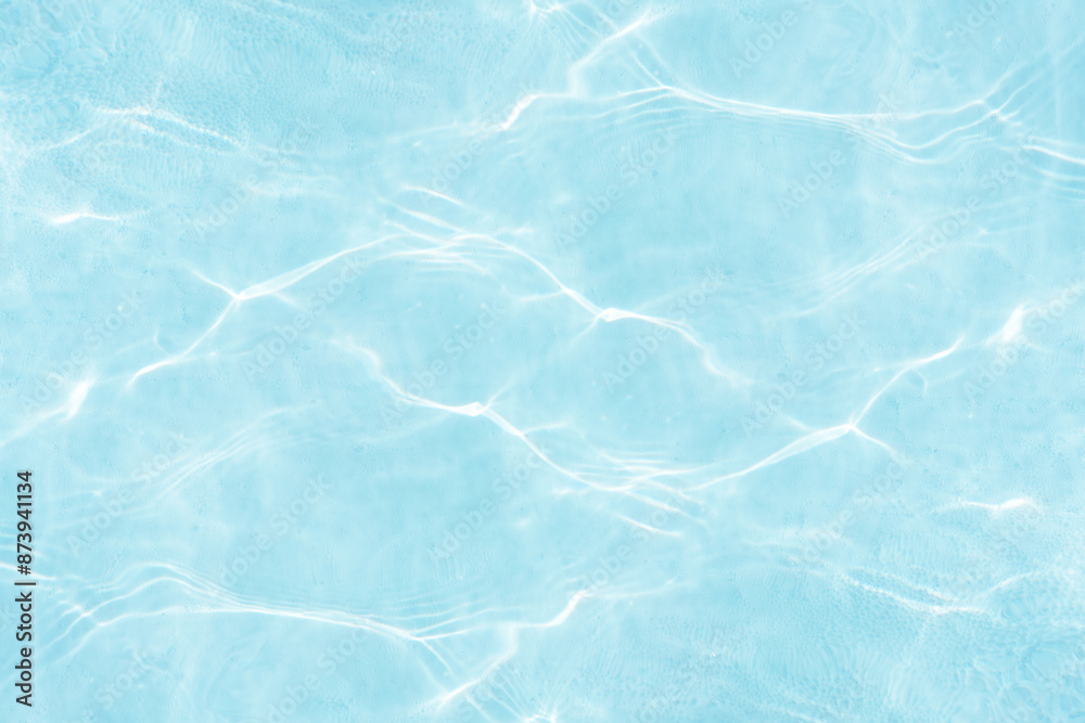 Blue water with ripples on the surface. Defocus blurred transparent blue colored clear calm water surface texture with splashes and bubbles. Water waves with shining pattern texture background. Blue water with ripples on the surface. Defocus blurred transparent blue colored clear calm water surface texture with splashes and bubbles. Water waves with shining pattern texture background.
