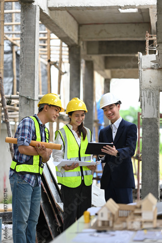 Team of structural engineers and businessman planning development details about project at construction site