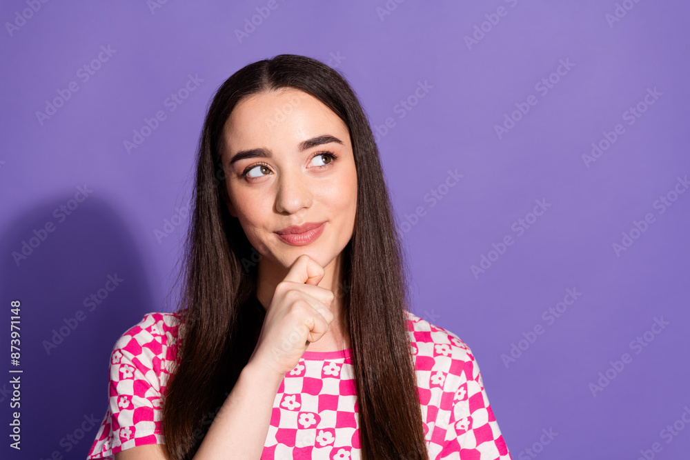 Photo of pretty young woman look empty space wear checkered t-shirt isolated on purple color background Photo of pretty young woman look empty space wear checkered t-shirt isolated on purple color background