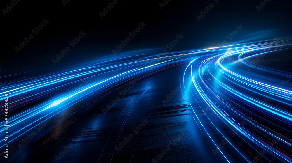 Obraz premium Dynamic blue light trails curving in the dark, representing speed and motion