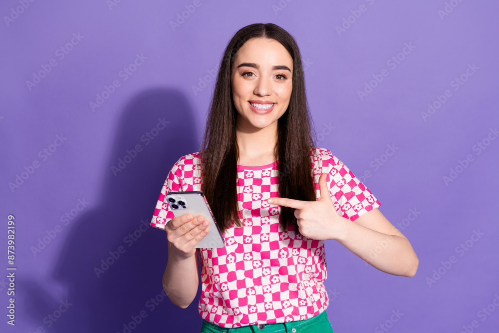 Photo portrait of lovely young lady hold point device dressed stylish pink garment isolated on violet color background Photo portrait of lovely young lady hold point device dressed stylish pink garment isolated on violet color background