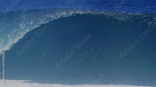 Medium view of textured strong powerful ocean water rising into wave with mist flying off top photo