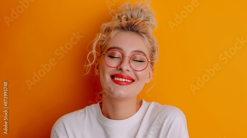 A woman with red lipstick and glasses is smiling at the camera. She is wearing a white shirt and has her hair in a bun. Concept of happiness and confidence