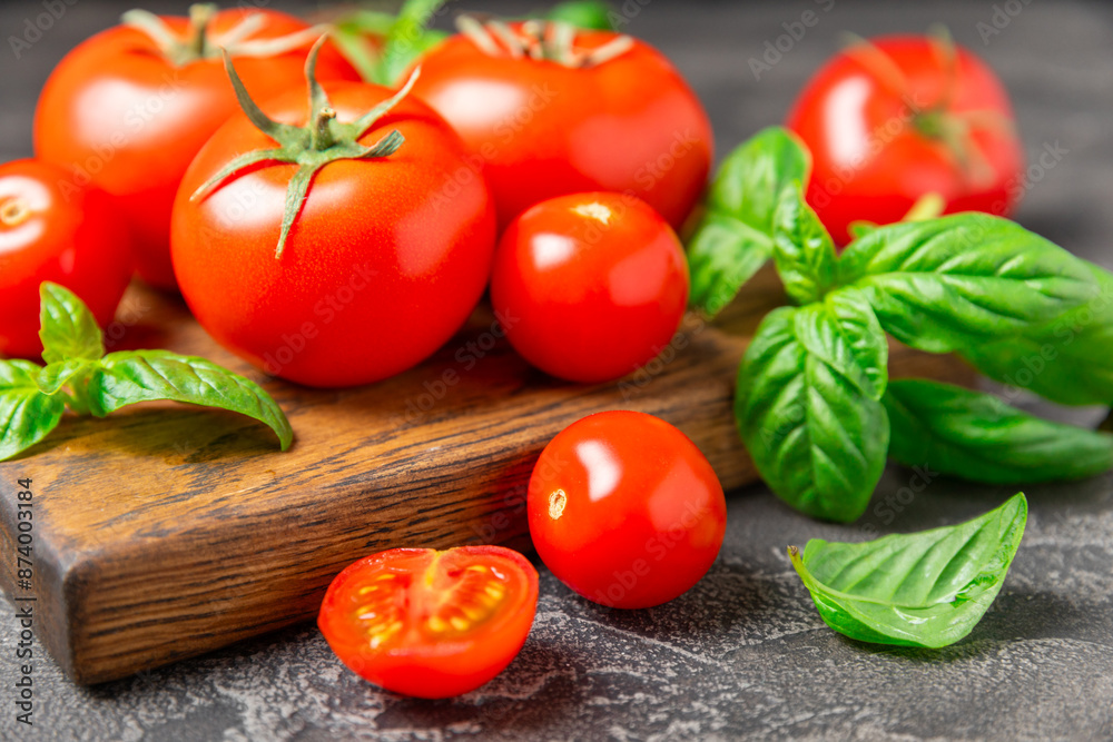 Fresh cherry tomatoes and fresh green basil on a textured background. Tomato sauce. Vegan. Ingredients for salad. Organic food. Place for text. Copy space. Fresh cherry tomatoes and fresh green basil on a textured background. Tomato sauce. Vegan. Ingredients for salad. Organic food. Place for text. Copy space.