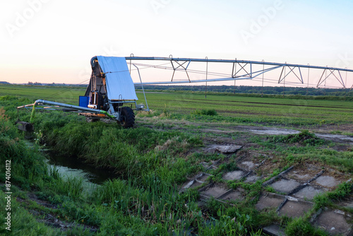 Field with mobile Irrigation system for water supply. Automatic field watering system.