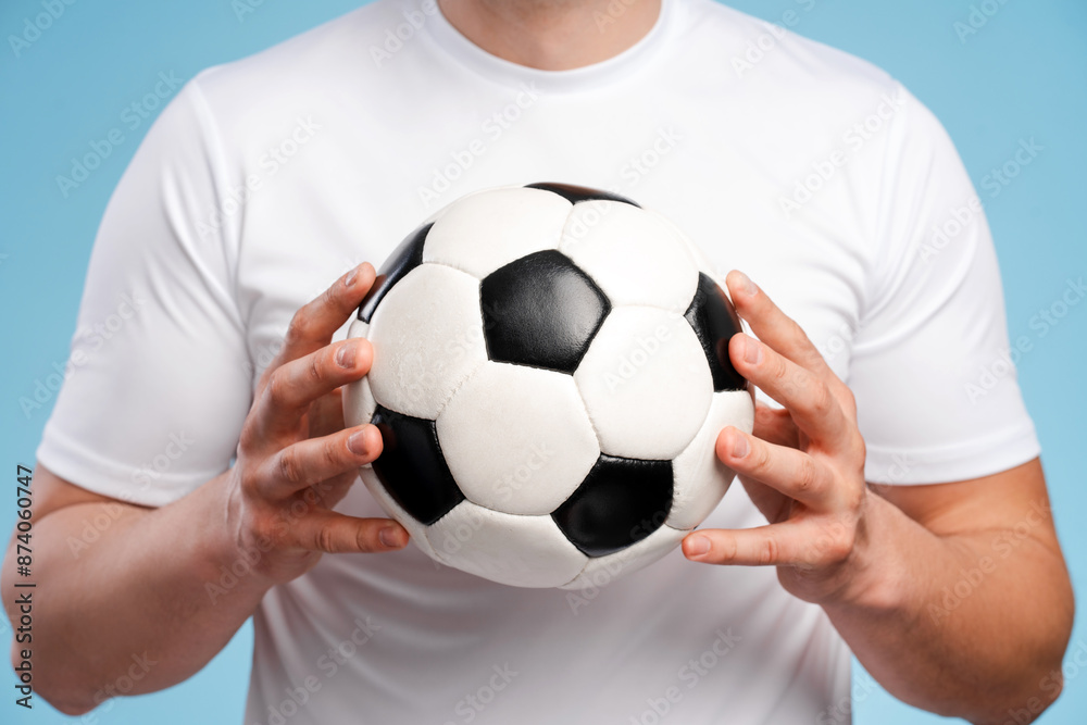 Soccer player holding classic black and white ball Soccer player holding classic black and white ball