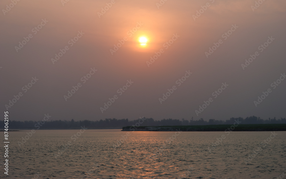 Naklejka premium sunrise over the river Brahmaputra in Bangladesh 