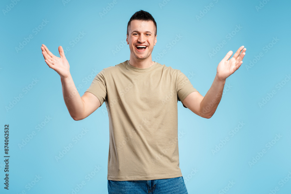 Smiling happy man in casual clothes rejoicing, glad to see, isolated on blue background Smiling happy man in casual clothes rejoicing, glad to see, isolated on blue background