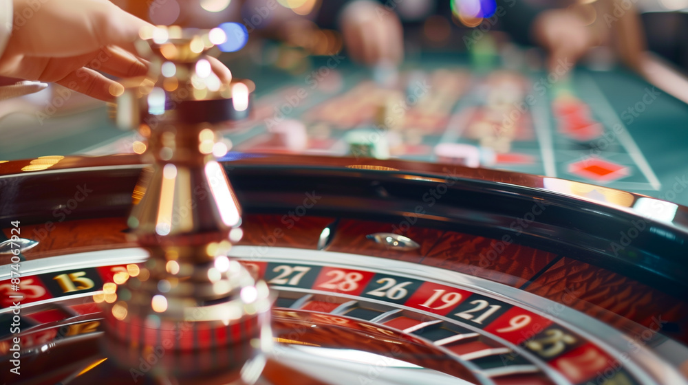 Obraz premium close up of a roulette plate in casino with blurred players in the background