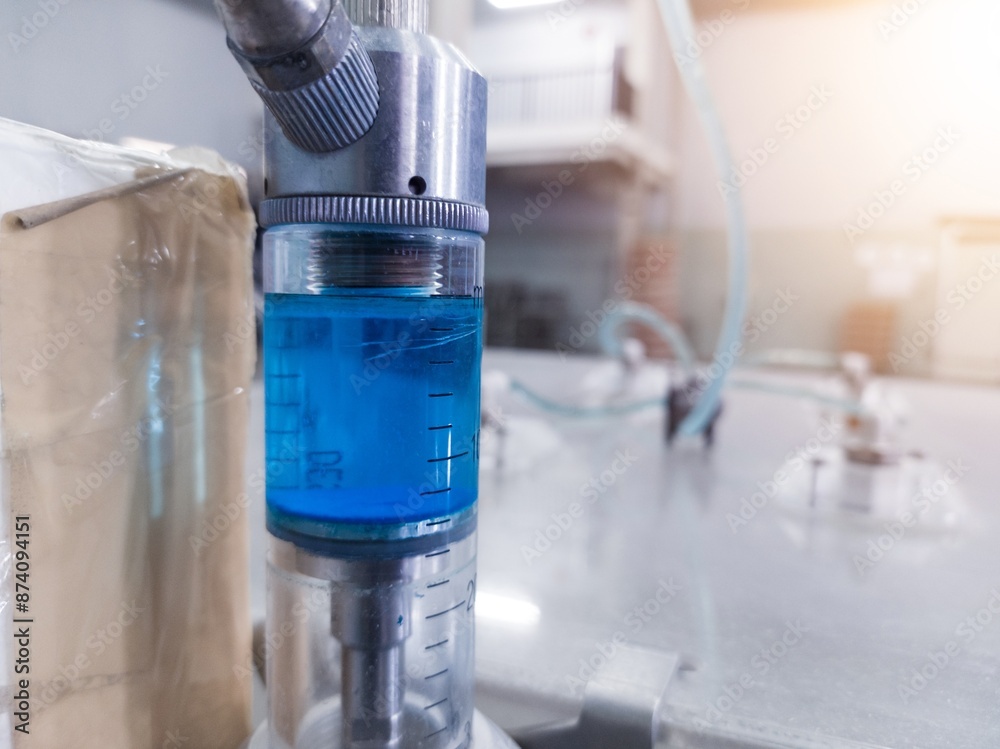 Close up the piston cylinder tube contains medicinal liquid for spray vaccine for hatching chicks.