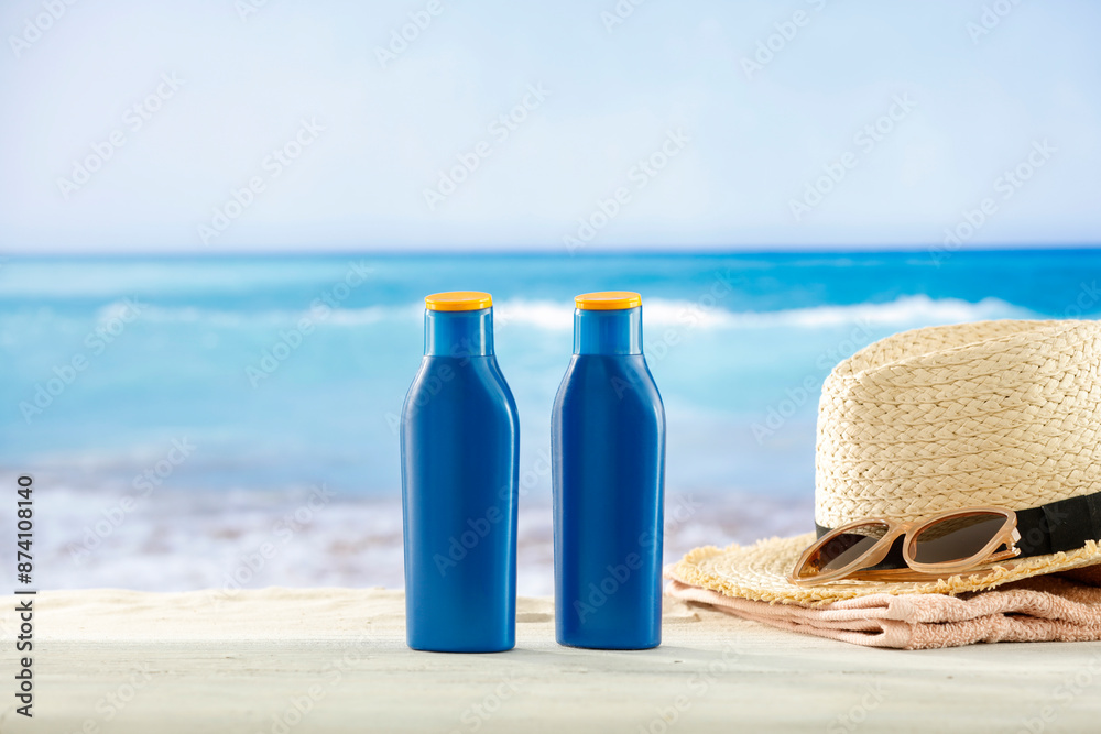 Blue containers for sun tan lotion and sunscreen oils on a bright table ...
