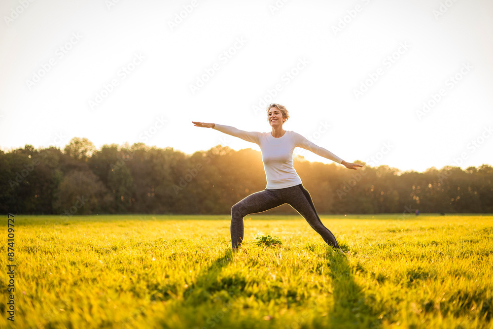 Happy senior woman exercising in park on sunny day Happy senior woman exercising in park on sunny day