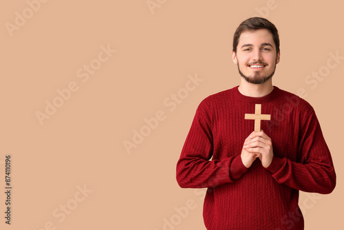Smiling man with cross on b...