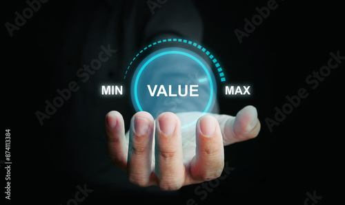 Business value added concept. A man holds a virtual icon of increasing value added to the product, business, or service.