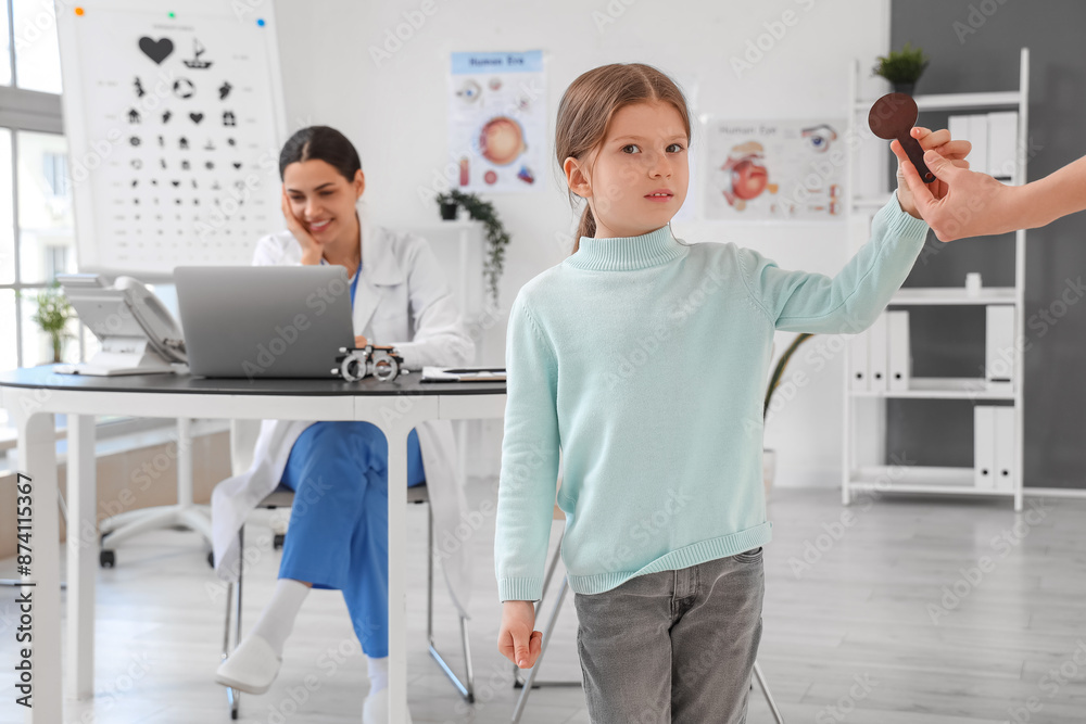 Little girl taking occluder in eye clinic Little girl taking occluder in eye clinic