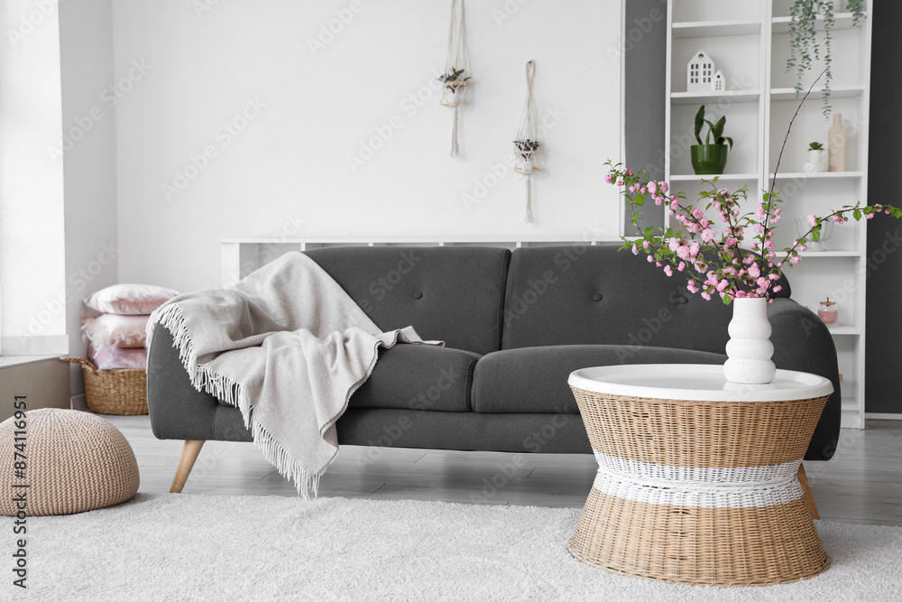 © Pixel-Shot - Modern interior of living room with sofa and coffee table with blooming branches