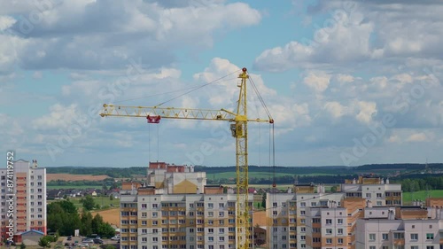 Moving Crane In The City. Field At The Background. Sunny Day. Construction Site